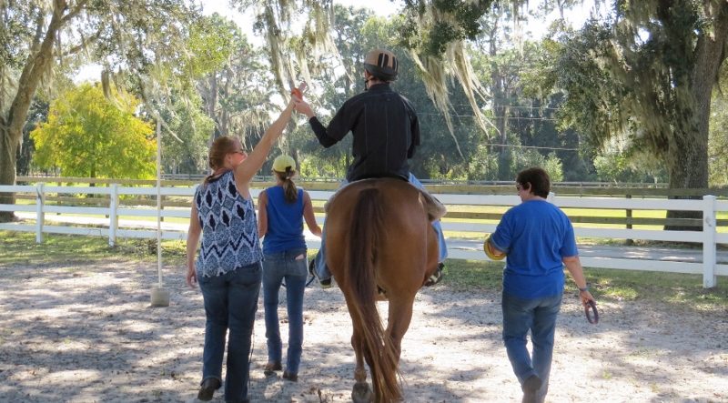 Rider walking with trainer