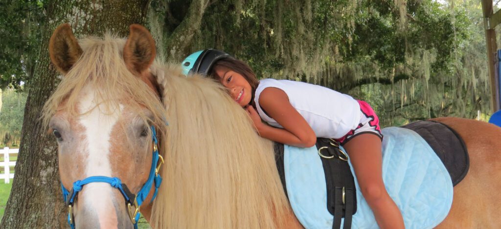 A woman riding on the back of a horse.